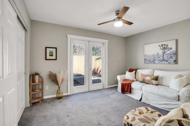 carpeted living room with ceiling fan