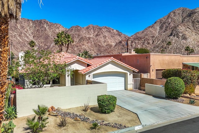 view of front facade with a mountain view and a garage