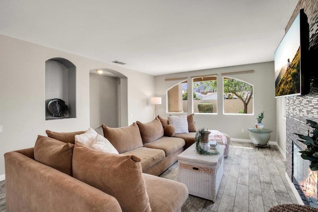 living room featuring a fireplace and hardwood / wood-style flooring