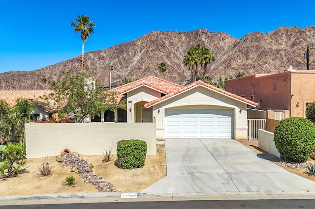 view of front of house with a mountain view and a garage