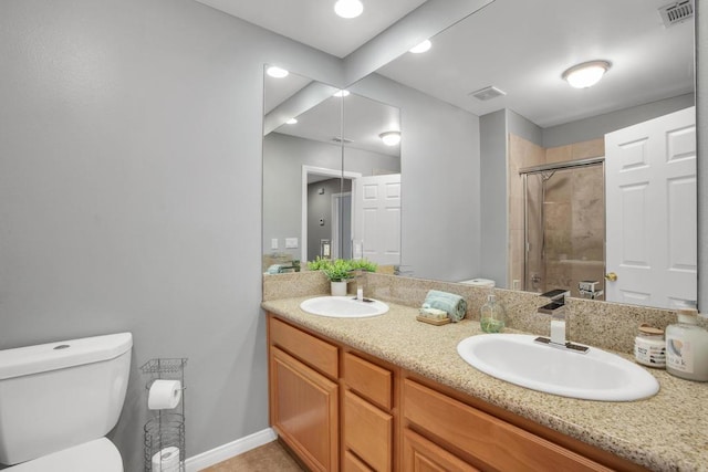 bathroom featuring an enclosed shower, vanity, and toilet