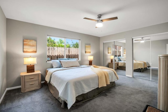 carpeted bedroom featuring ceiling fan and two closets