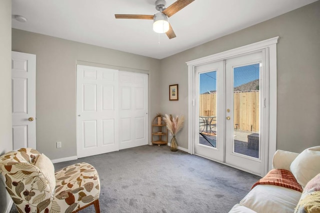 sitting room featuring ceiling fan, french doors, and carpet flooring