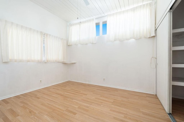 unfurnished room featuring light wood-type flooring, wooden ceiling, and ceiling fan