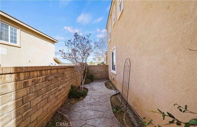 view of side of property featuring a patio