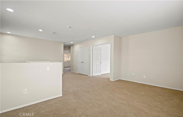 empty room featuring light carpet