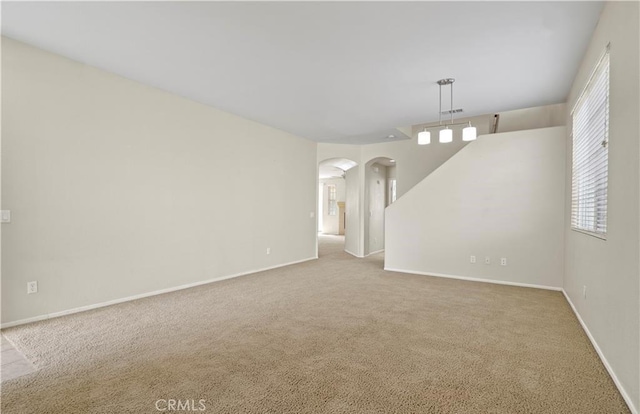 unfurnished room featuring light colored carpet