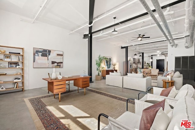 living room with concrete floors and ceiling fan