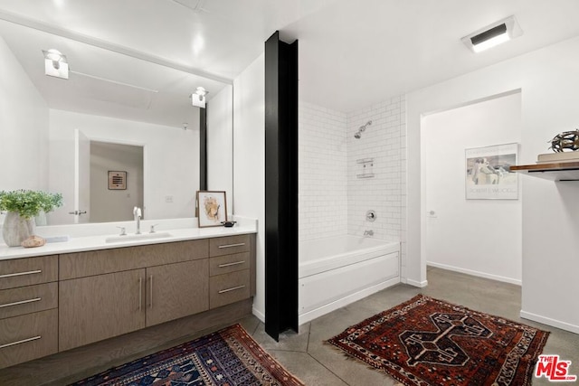 bathroom with tiled shower / bath combo, vanity, and concrete floors