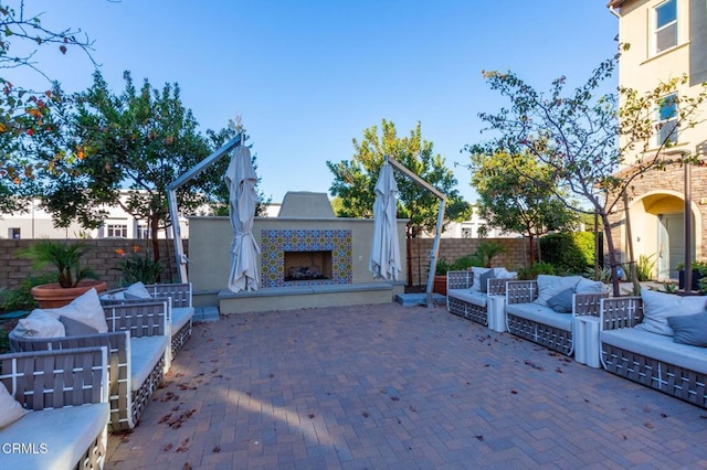 view of patio featuring an outdoor living space with a fireplace