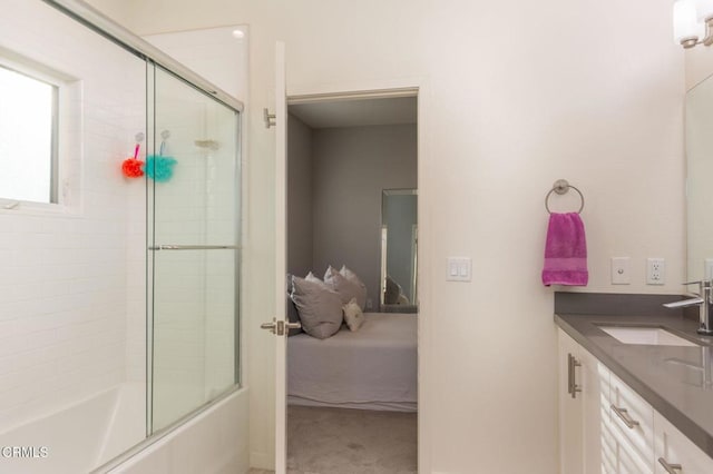 bathroom featuring vanity and bath / shower combo with glass door