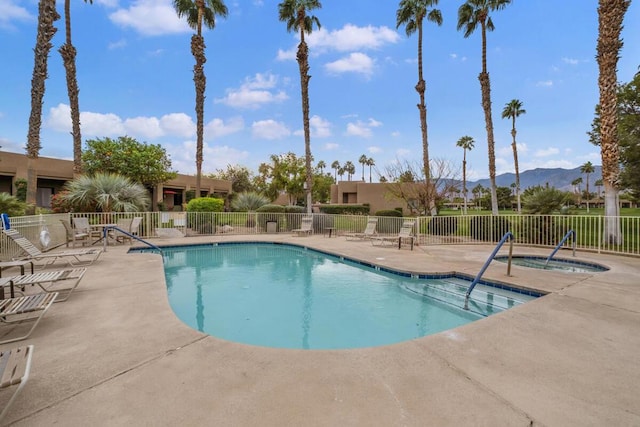 view of pool featuring a mountain view and a patio