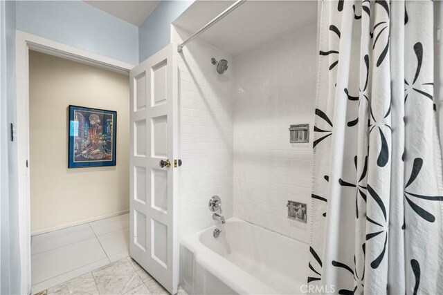 bathroom with shower / bath combination with curtain and tile patterned floors