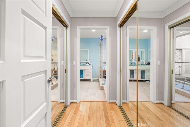 hallway with crown molding and hardwood / wood-style floors