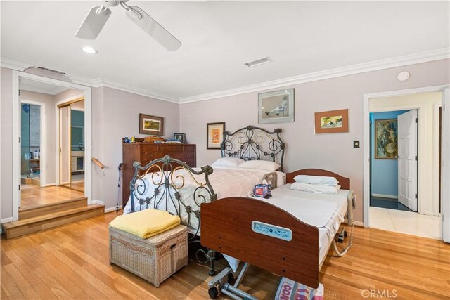 bedroom with ceiling fan, light hardwood / wood-style flooring, and ornamental molding