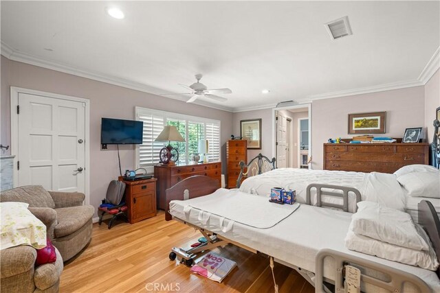 bedroom with ceiling fan, crown molding, and light hardwood / wood-style flooring