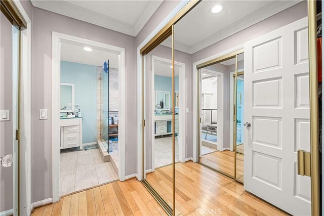 hall with crown molding and hardwood / wood-style flooring