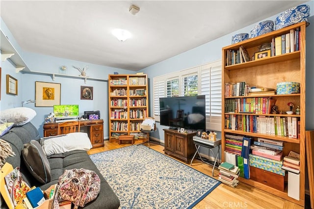 living room with lofted ceiling and light hardwood / wood-style flooring