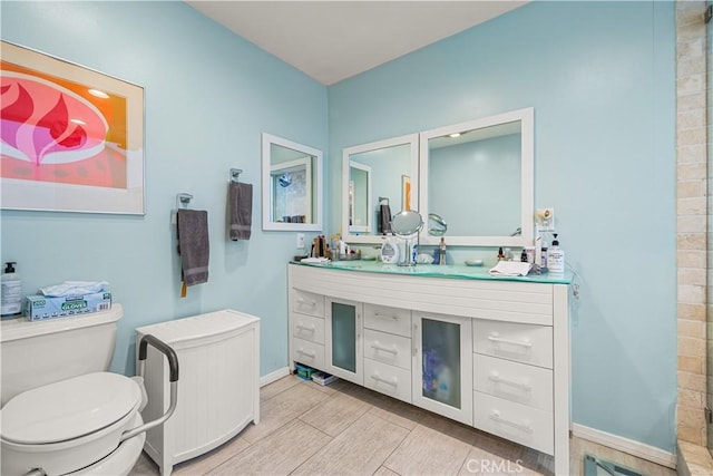 bathroom featuring toilet and vanity