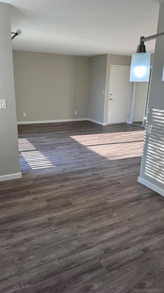 spare room featuring dark hardwood / wood-style flooring