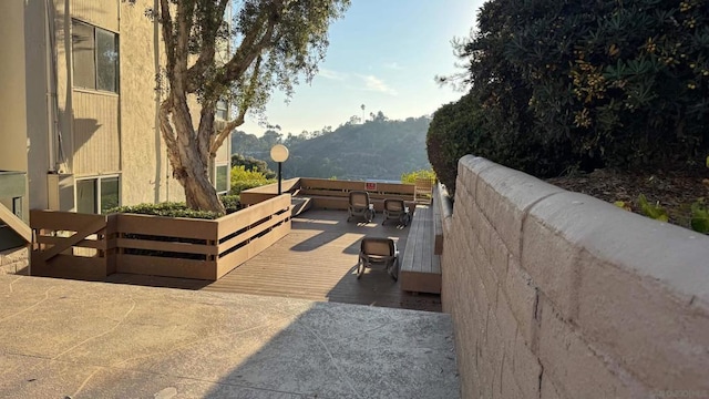 view of patio / terrace with a deck with mountain view