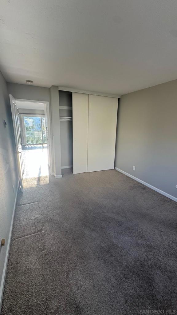 unfurnished bedroom with a closet and carpet flooring