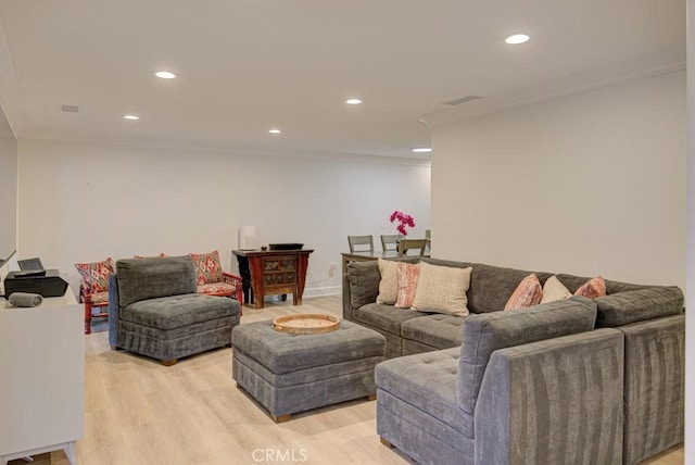 living room featuring light hardwood / wood-style flooring and ornamental molding