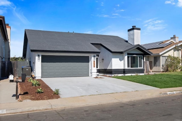 view of front of house featuring a garage and a front lawn