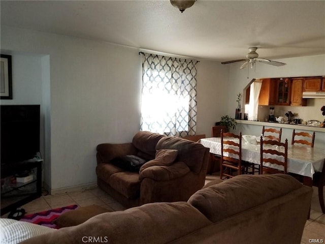 living room with ceiling fan and light tile patterned floors