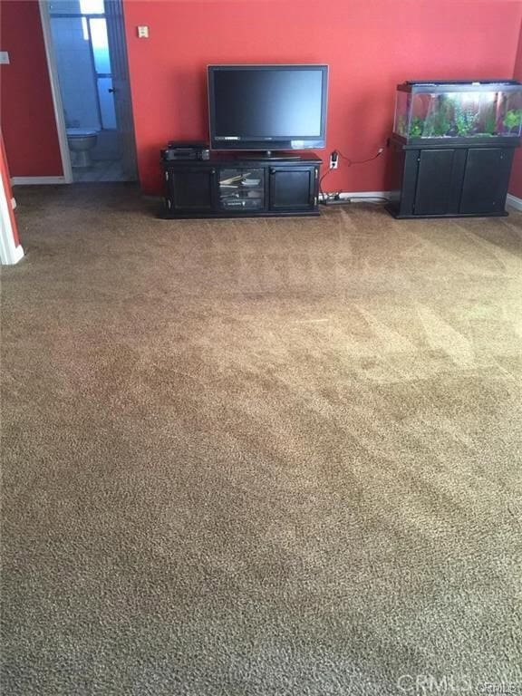 unfurnished living room featuring carpet