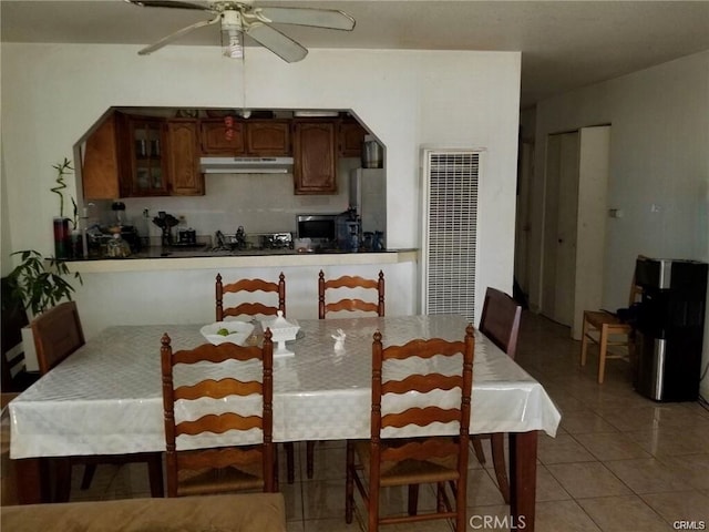 dining area with ceiling fan and light tile patterned flooring