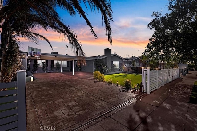 view of front of property with a lawn and a patio