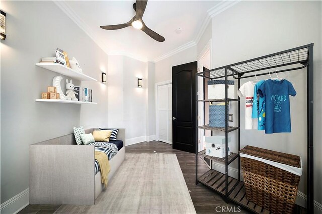 interior space featuring ceiling fan, dark wood-type flooring, and ornamental molding