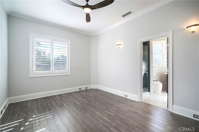 spare room featuring dark wood-type flooring, crown molding, and ceiling fan