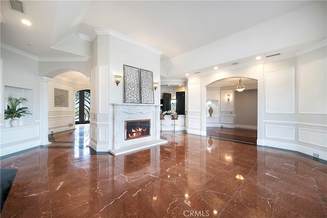 unfurnished living room featuring ornamental molding