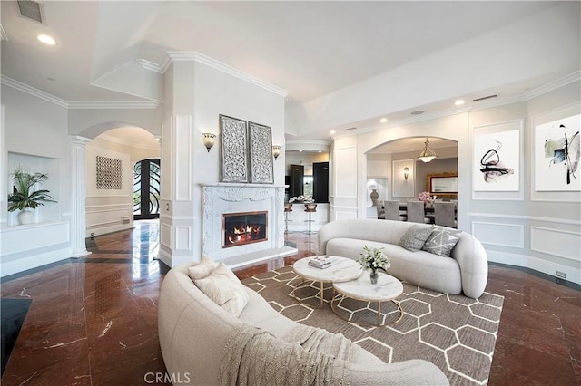 living room featuring crown molding and a fireplace