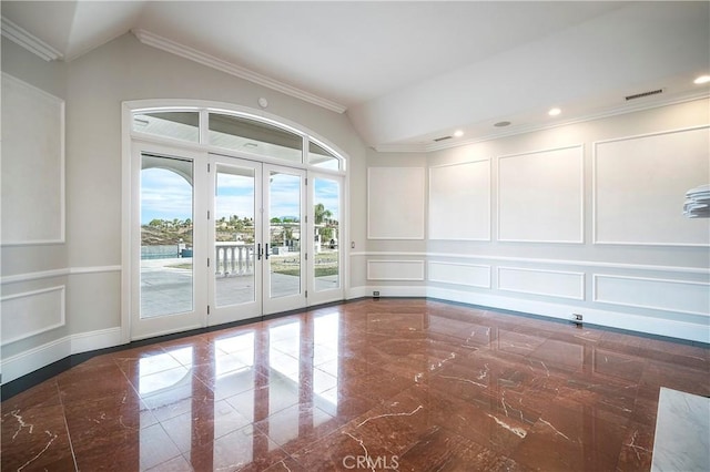 spare room with lofted ceiling, ornamental molding, and french doors