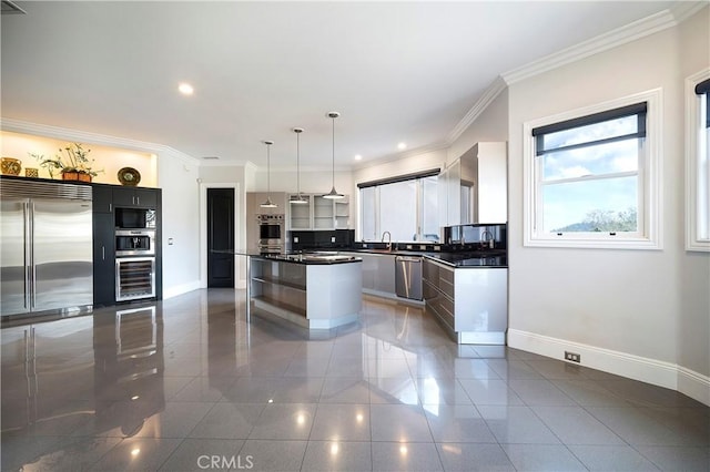 kitchen with black appliances, pendant lighting, a kitchen island, crown molding, and sink