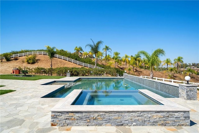 view of swimming pool with a patio and an in ground hot tub