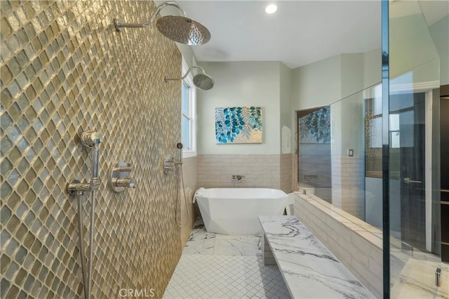 bathroom featuring tile walls and separate shower and tub