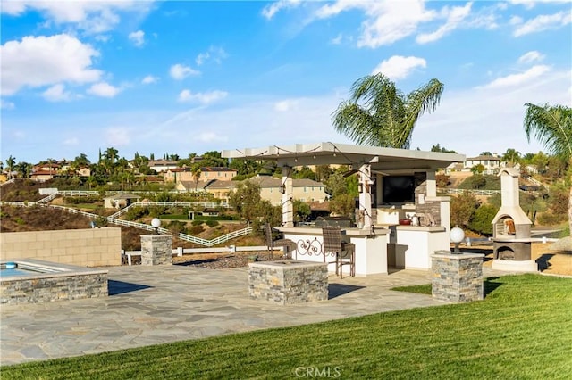 view of patio / terrace featuring an outdoor stone fireplace