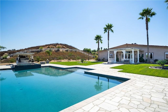 view of pool featuring a lawn and a patio area