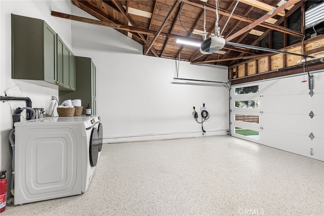 garage featuring washing machine and dryer and a garage door opener