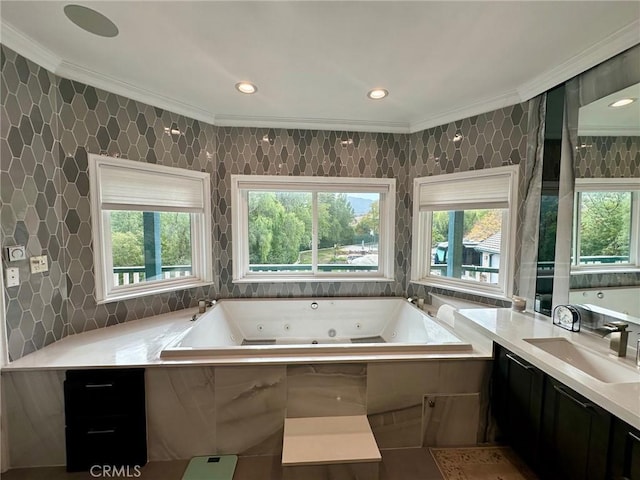 bathroom featuring tiled bath, crown molding, vanity, and tile walls