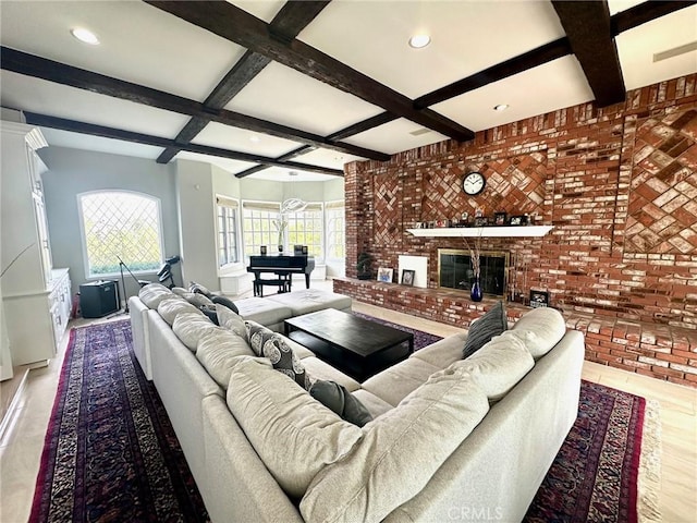 living room featuring a fireplace, brick wall, coffered ceiling, and beamed ceiling