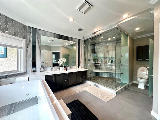 bathroom with toilet, vanity, a shower with door, and ornamental molding