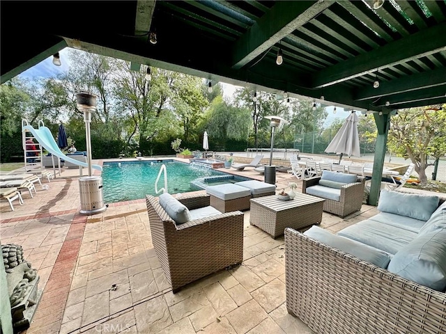 view of swimming pool with an in ground hot tub, outdoor lounge area, a water slide, and a patio