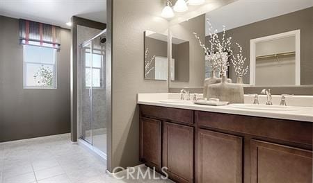 bathroom with vanity, tile patterned flooring, and a shower with door