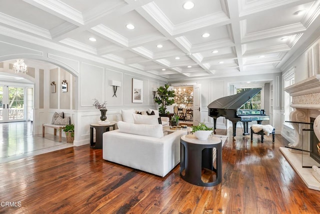 living room with coffered ceiling, dark hardwood / wood-style flooring, beamed ceiling, and a healthy amount of sunlight