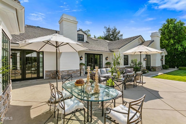 view of patio / terrace with an outdoor living space and french doors